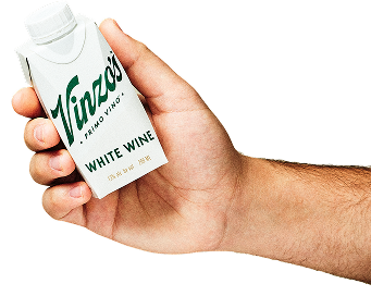 A person's hand holding a 500ml carton of Vinzo's Primo Vino Red Wine.